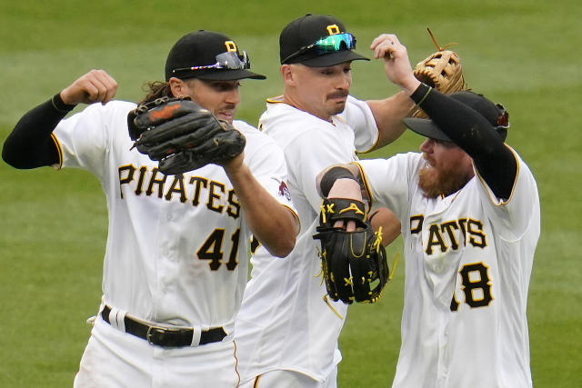 Pittsburgh Pirates' Bryan Reynolds (10) is welcomed at the dugout steps by  manager Derek Shelton, left, after hitting a solo home run off Chicago Cubs  starting pitcher Alec Mills during the second