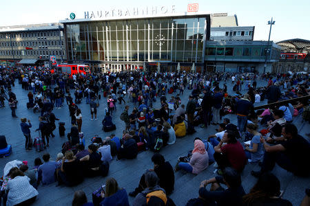 Passengers wait outside the main train station in Cologne, Germany, October 15, 2018, after the train station was closed after hostage-taking. REUTERS/Thilo Schmuelgen