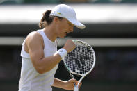 Poland's Iga Swiatek returns the ball to France's Alize Cornet during a third round women's singles match on day six of the Wimbledon tennis championships in London, Saturday, July 2, 2022. (AP Photo/Kirsty Wigglesworth)