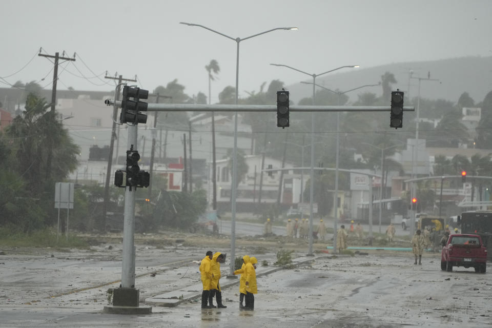 Mexican soldiers and rescue team remove mud and sludge from a avenue flooded by the rains of Hurricane Norma in San Jose del Cabo, Mexico, Saturday, Oct. 21, 2023. Norma had weakened and was downgraded to Category 1 on the hurricane wind scale. It was located 25 miles west of Cabo San Lucas storm with winds of 85 mph (140 kmh) and expected to make landfall on Saturday, according to the U.S. (AP Photo/Fernando Llano)