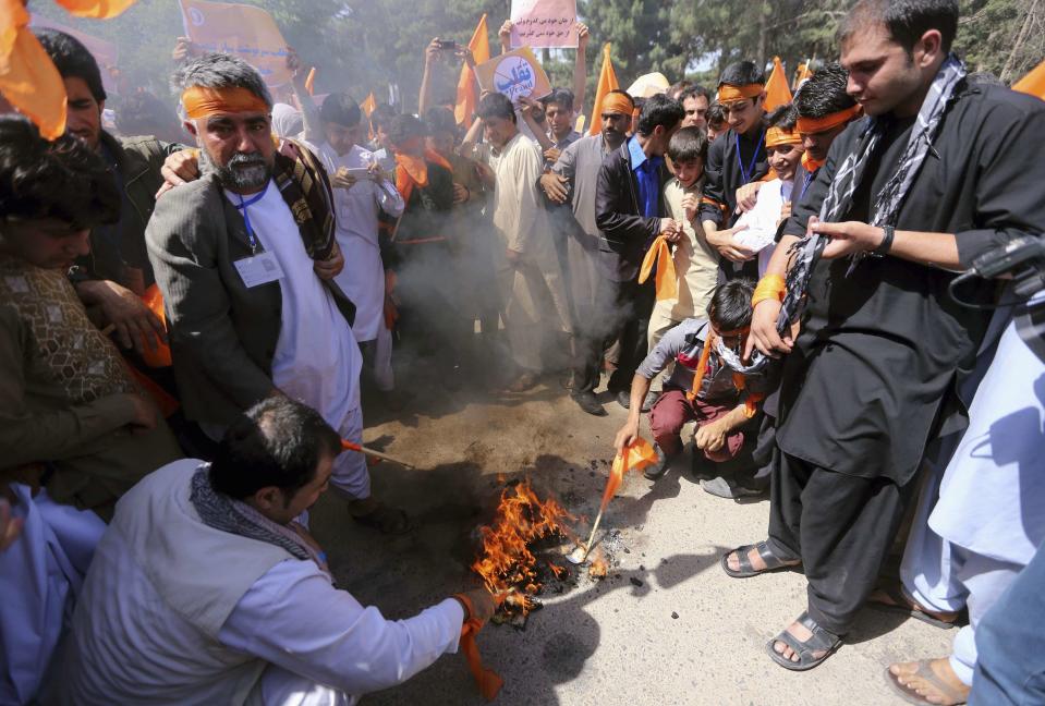 Afghan demonstrators burn their election ID cards during a protest in support of presidential candidate Abdullah Abdullah in Herat province, June 22, 2014. Protests in support of Afghan presidential candidate Abdullah's decision to drop out of the electoral process gathered in several cities on Sunday, as tension over allegations of mass-fraud in the run-off vote grew. (REUTERS/Mohammad Shoib)