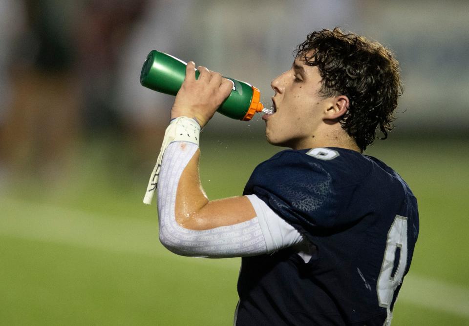 Reitz’s Roland Vera Jr. (9) drinks some water as the Reitz Panthers play the Vincennes Lincoln Alices at the Reitz Bowl in Evansville, Ind., Friday, Aug. 25, 2023. The feel like temperature at the time was near 100 degrees.