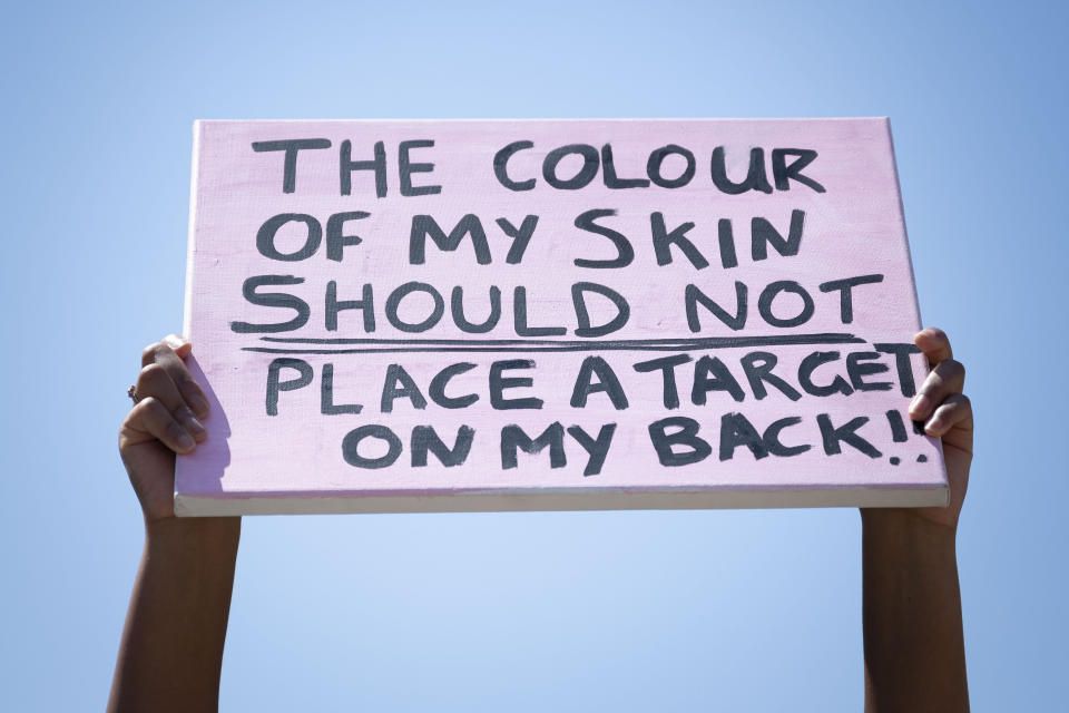 <i>A close-up of a sign that says: "The colour of my skin should not place a target on my back" during a May 31 protest outside Cardiff Castle in Wales.</i>