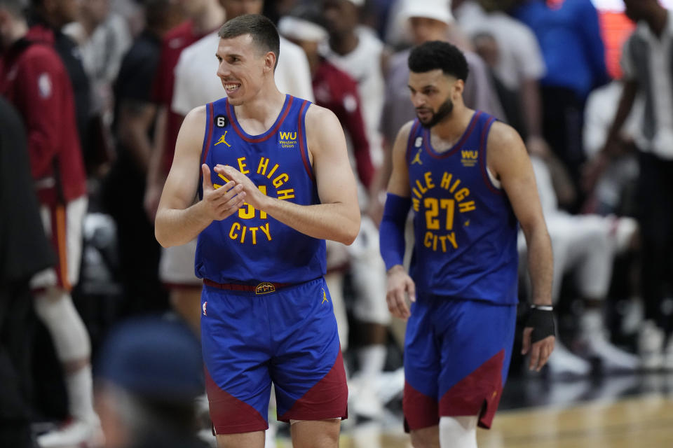 Denver Nuggets forward Vlatko Cancar (31) and guard Jamal Murray (27) smile during the second half of Game 3 of the basketball NBA Finals against the Miami Heat, Wednesday, June 7, 2023, in Miami. (AP Photo/Wilfredo Lee)