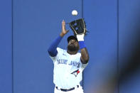 Toronto Blue Jays center fielder Jackie Bradley Jr. catches a fly ball off the bat of Cleveland Guardians' Oscar Gonzalez during the second inning of a baseball game Friday, Aug. 12, 2022, in Toronto. (Jon Blacker/The Canadian Press via AP)