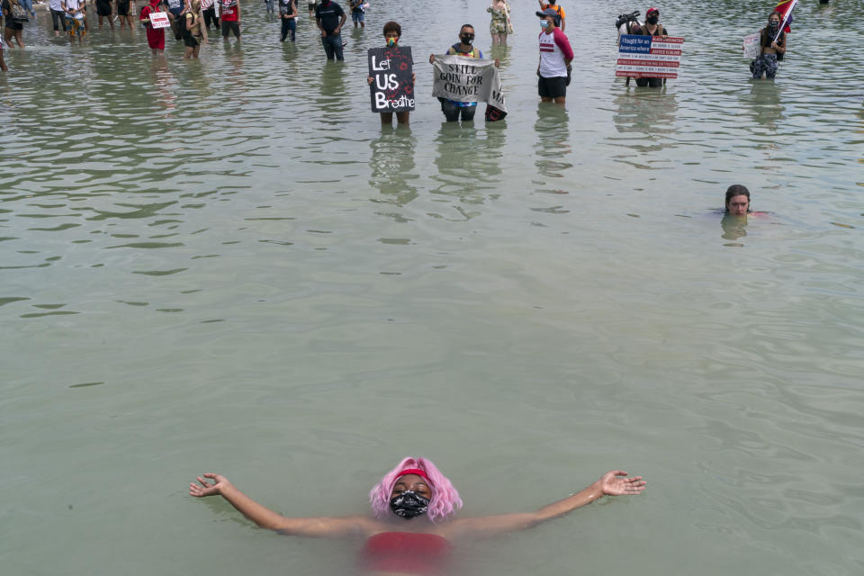 <strong>Washington, D.C., Aug. 28, 2020.</strong> Tens of thousands of peaceful protesters gathered on the 57th anniversary of the March on Washington to call for social and racial justice. Held on a sweltering day, some attendees cooled in the waters of the Lincoln Memorial Reflecting Pool.<span class="copyright">Peter van Agtmael—Magnum Photos</span>