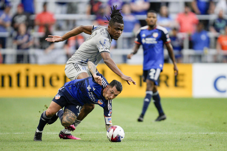 FC Cincinnati midfielder Luciano Acosta (10) battles against CF Montréal's Chinonso Offor during the first half of an MLS soccer match Wednesday, May 17, 2023, in Cincinnati. (AP Photo/Jeff Dean)