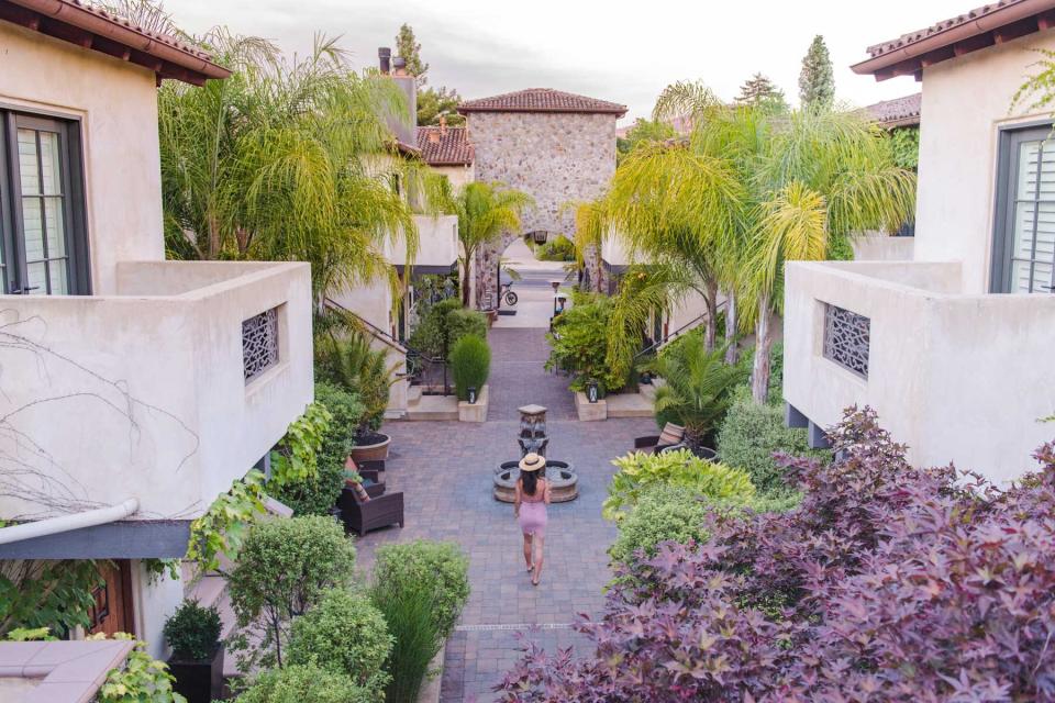 Woman walking through the courtyard of the North Block Resort in California