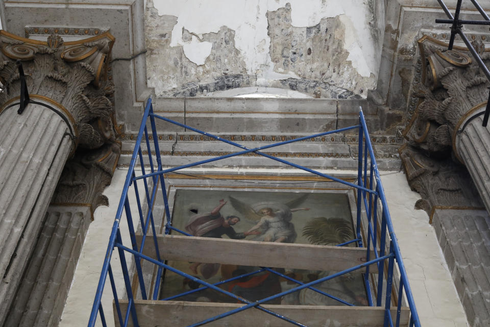 Scaffolding stands in front of a damaged painting and a section of the damaged vault, during the early stages of reconstruction work at Nuestra Senora de Los Angeles, or Our Lady of Angels church, three years after an earthquake collapsed nearly half of its 18th-century dome in Mexico City, Tuesday, Oct. 6, 2020. The chapel built in the late 1500s once stood here, of which only a portion of one wall remains, while the collapsed dome was built between 1740 and 1884. (AP Photo/Rebecca Blackwell)