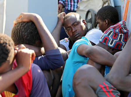 FILE PHOTO: Migrants in a boat arrive at a naval base after they were rescued by Libyan coastguard, in Tripoli, Libya August 29, 2017. REUTERS/Hani Amara/File Photo