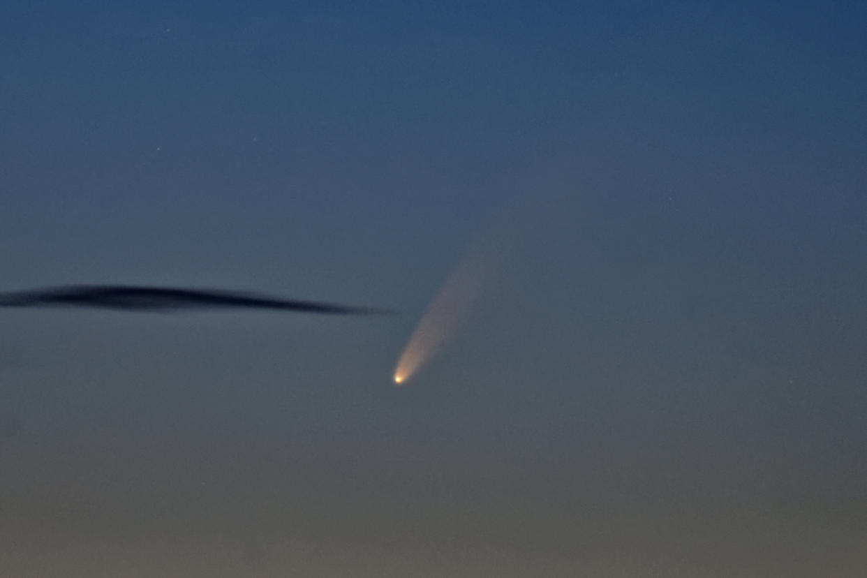 The comet C2020 F3 NEOWISE is seen above the horizon from Brancaster beach, Norfolk (Getty) 
