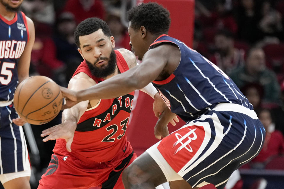 Toronto Raptors guard Fred VanVleet (23) attempts to steal the ball from Houston Rockets forward Jae'Sean Tate during the first half of an NBA basketball game, Friday, Feb. 3, 2023, in Houston. (AP Photo/Eric Christian Smith)