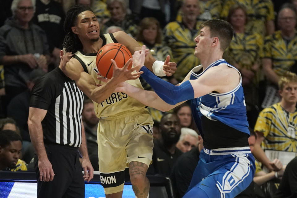 Duke's Kyle Filipowski, right, fouls Wake Forest's Hunter Sallis, left, during the second half of an NCAA college basketball game in Winston-Salem, N.C., Saturday, Feb. 24, 2024. (AP Photo/Chuck Burton)