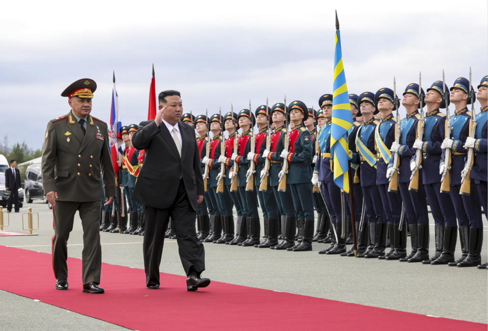 In this photo released by Russian Defense Ministry Press Service, North Korea's leader Kim Jong Un, center, and Russian Defense Minister Sergei Shoigu, left, arrive to inspect Russian warplanes at the Vladivostok International airport in Vladivostok, Russian Far East on Saturday, Sept. 16, 2023. (Russian Defense Ministry Press Service via AP)
