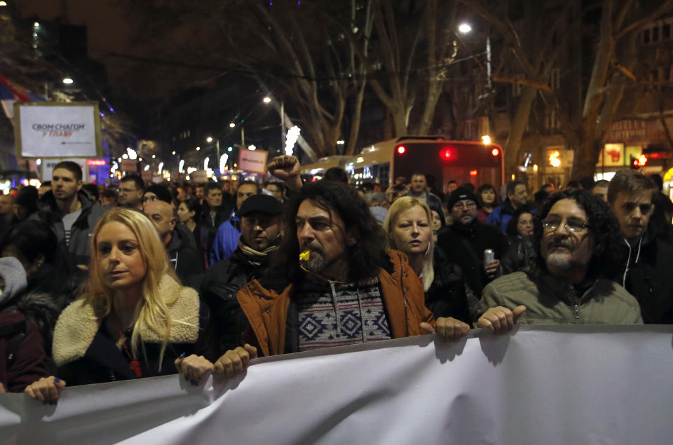 People march during a protest against populist President Aleksandar Vucic in Belgrade, Serbia, Saturday, Dec. 22, 2018. Thousands of people have rallied in another protest in Serbia against populist President Aleksandar Vucic accusing him of stifling hard-won democratic freedoms and cracking down on opponents. (AP Photo/Darko Vojinovic)