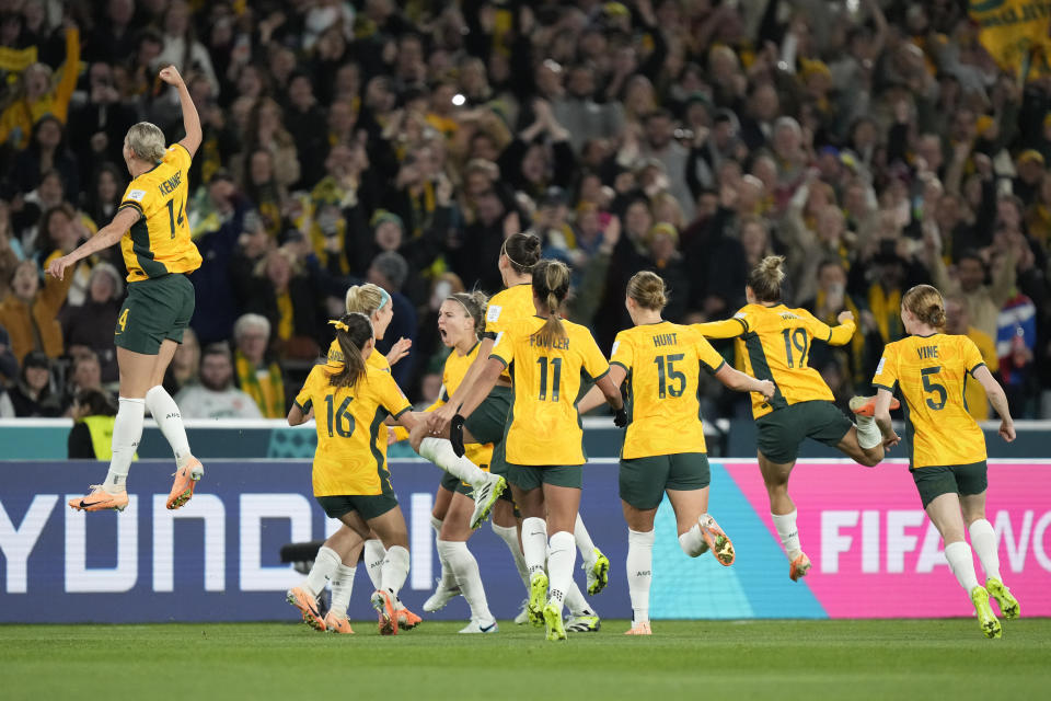 Australia players celebrate after teammate Steph Catley scored the opening goal during the Women's World Cup soccer match between Australia and Ireland at Stadium Australia in Sydney, Australia, Thursday, July 20, 2023. (AP Photo/Rick Rycroft)