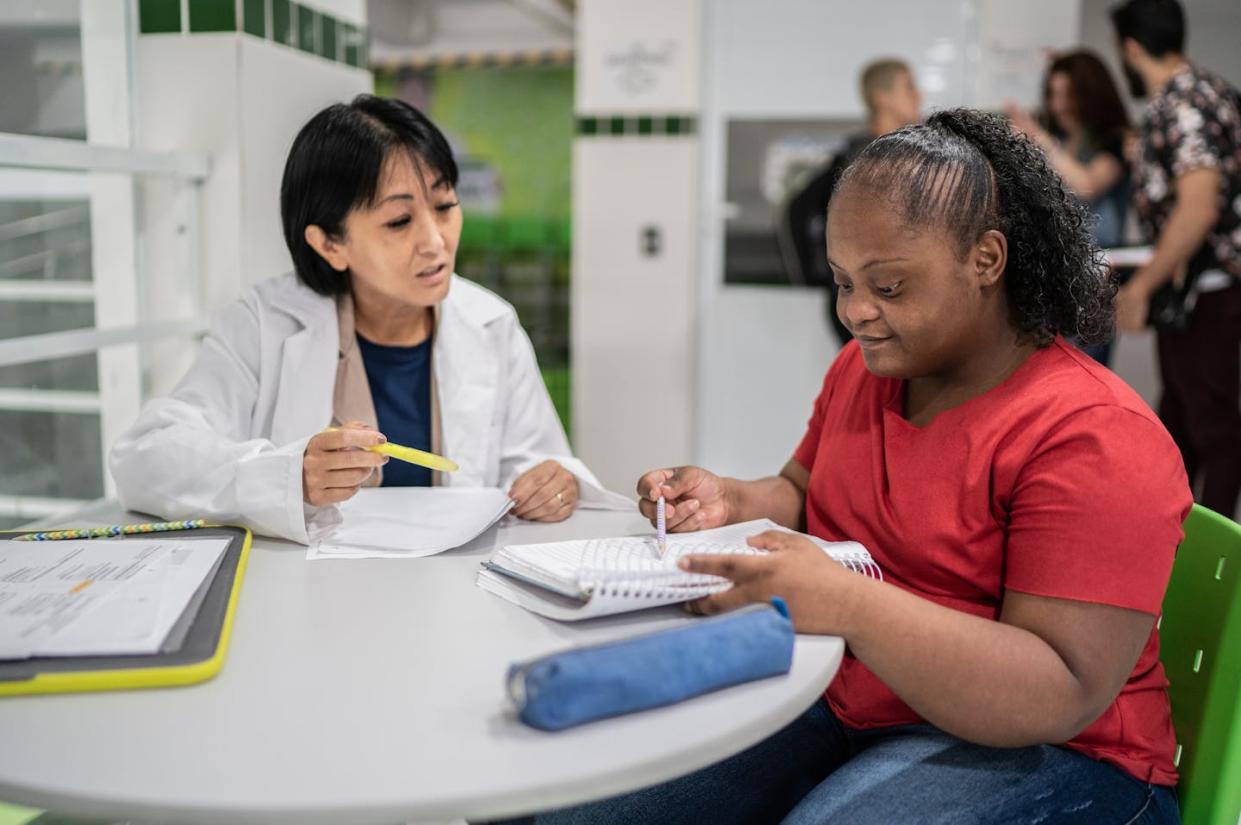 <span class="caption">Conversations around race and disability often get left out of schools. </span> <span class="attribution"><a class="link " href="https://www.gettyimages.com/detail/photo/teacher-helping-special-needs-student-at-school-royalty-free-image/1364983986?adppopup=true" rel="nofollow noopener" target="_blank" data-ylk="slk:FG Trade/E+ via Getty Images;elm:context_link;itc:0;sec:content-canvas">FG Trade/E+ via Getty Images</a></span>