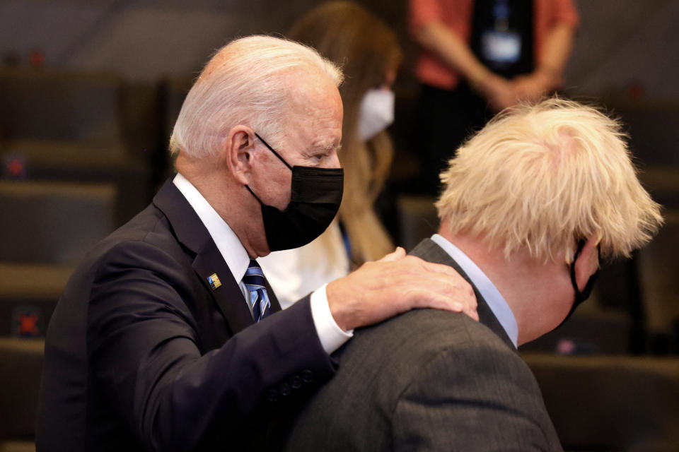 US President Joe Biden (L) greets Britain's Prime Minister Boris Johnson during a plenary session of a NATO summit at the North Atlantic Treaty Organization (NATO) headquarters in Brussels, on June 14, 2021. - The allies will agree a statement stressing common ground on securing their withdrawal from Afghanistan, joint responses to cyber attacks and relations with a rising China. (Photo by Olivier Matthys / POOL / AFP) (Photo by OLIVIER MATTHYS/POOL/AFP via Getty Images)