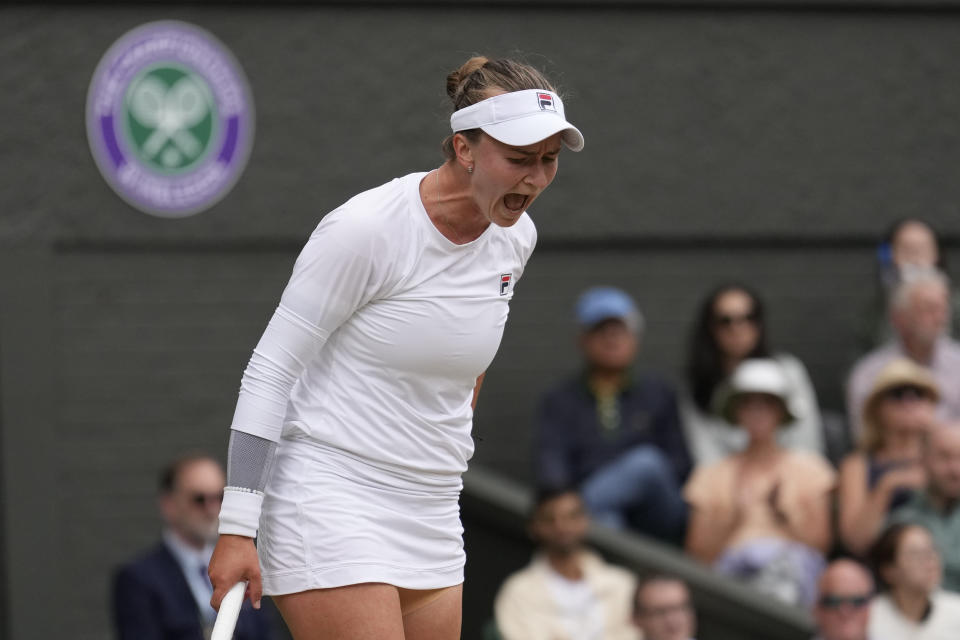 Barbora Krejcikova of the Czech Republic reacts after missing a shot as she plays against Jasmine Paolini of Italy during the women's singles final at the Wimbledon tennis championships in London, Saturday, July 13, 2024. (AP Photo/Mosa'ab Elshamy)