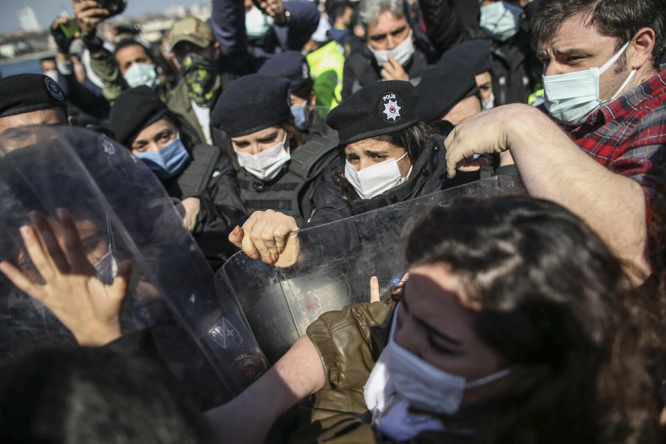 Turkish police officers scuffle with protesters during a demonstration in Istanbul,Saturday, March 27, 2021, against Turkey's withdrawal from Istanbul Convention, an international accord designed to protect women from violence. The Istanbul Convention states that men and women have equal rights and obliges national authorities to take steps to prevent gender-based violence against women, to protect victims and to prosecute perpetrators. Conservative groups and some officials from Turkeys President Recep Tayyip Erdogan's Islamic-oriented ruling party take issue with these terms, saying they promote homosexuality. (AP Photo/Emrah Gurel)