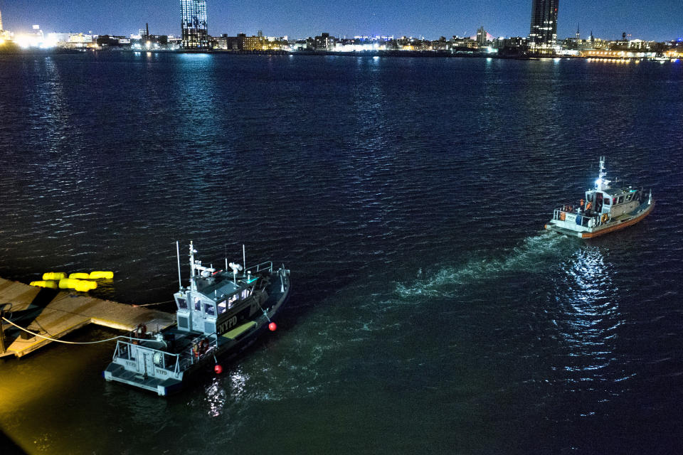 <em>Yellow buoys that a New York police officer said are suspending the helicopter that crashed into the East River (AP)</em>