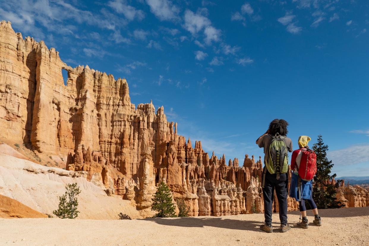 Hikers look out at Bryce Canyon's Wall of Windows.