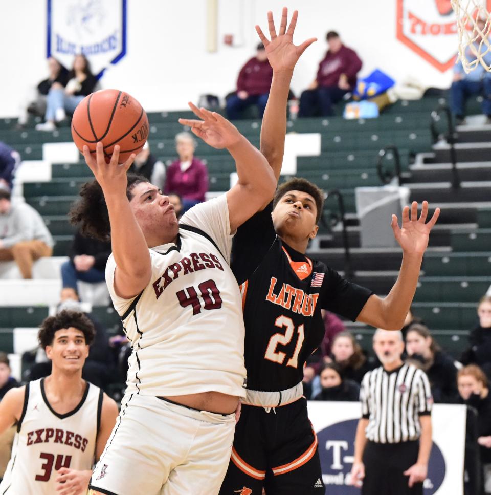 Elmira's Chris Woodard (40) goes up for a shot as Greater Latrobe's JaTawn Williams (21) defends during the Express' 69-62 win in a Boys National Division consolation game at the Josh Palmer Fund Clarion Classic on Dec. 29, 2023 at Elmira High School.
