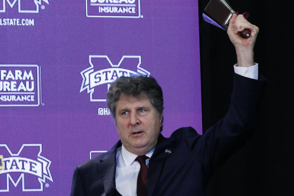 New Mississippi State NCAA college football coach Mike Leach rings the symbolic cowbell at a news conference Friday, Jan. 10, 2020, at the Starkville, Miss., based university, after being officially introduced as the head coach. (AP Photo/Rogelio V. Solis)