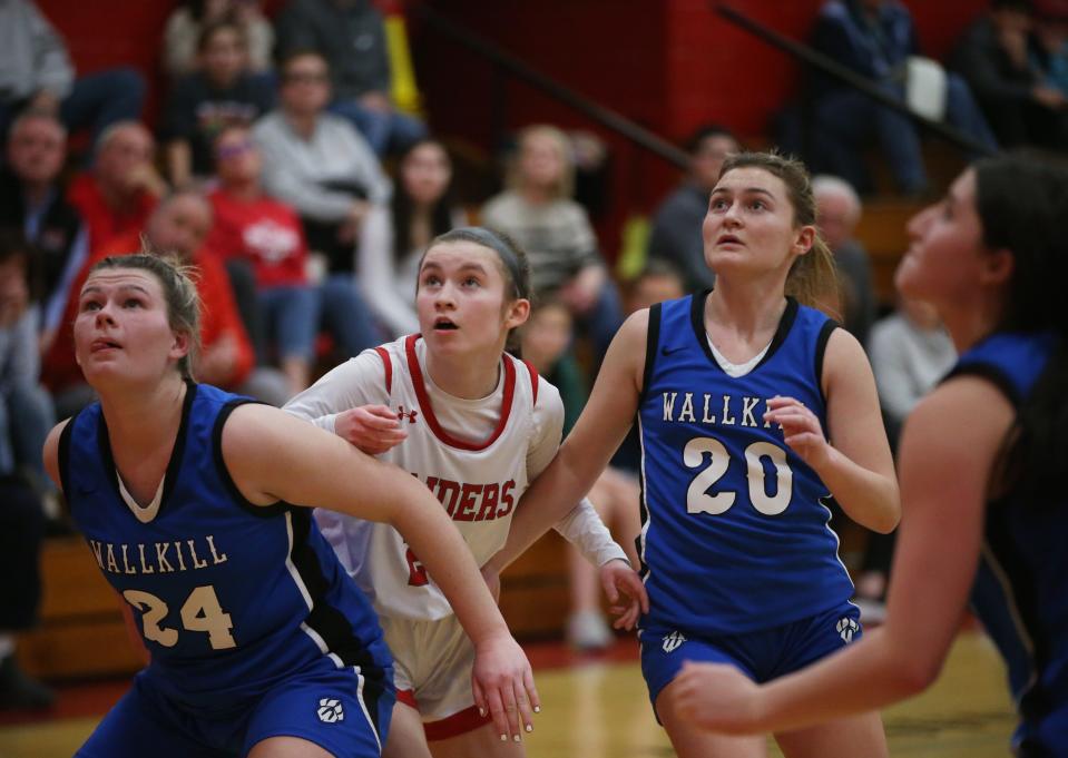 Red Hook's Maddie Clements anticpates a rebound as she's covered by Wallkill's, from left, Sam Dembinsky and Emma DiLemme on January 12, 2024.