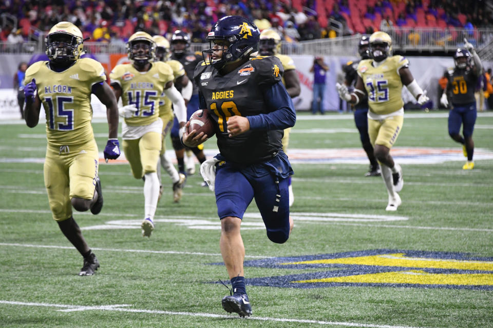 North Carolina A&T quarterback Kylil Carter is pursued by Alcorn State players during the second half of the Celebration Bowl NCAA college football game, Saturday, Dec. 21, 2019, in Atlanta. North Carolina A&T won 64-44. (John Amis/Atlanta Journal-Constitution via AP)