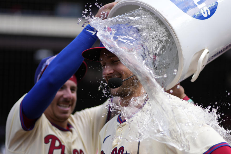 Philadelphia Phillies' Trea Turner, right, is dunked by Bryson Stott after the Phillies won a baseball game against the Miami Marlins, Sunday, June 30, 2024, in Philadelphia. (AP Photo/Matt Slocum)
