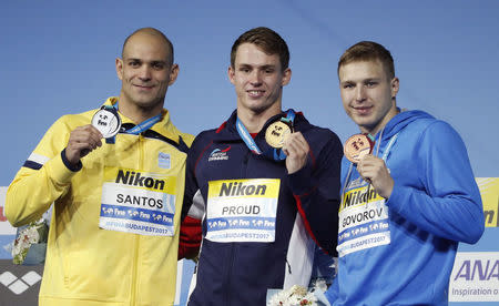 Swimming – 17th FINA World Aquatics Championships – Men's 50m Butterfly awarding ceremony – Budapest, Hungary – July 24, 2017 – (L-R) Nicholas Santos (silver) of Brasil, Benjamin Proud (gold) of Britain and Andrii Govorov (bronze) of Ukraine pose with the medals. REUTERS/Bernadett Szabo