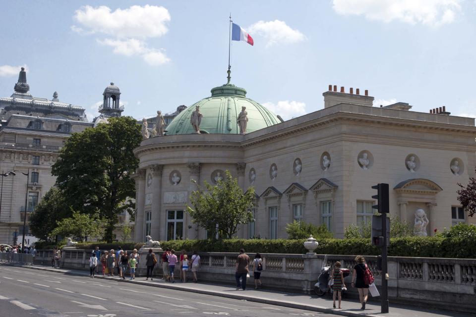 In this photo taken Friday, July 19, 2013, people walk in front of Legion of Honour building next to Musée d'Orsay during a guided tour in Paris. The building was the inspiration for Thomas Jefferson's Monticello house in Charlottesville, Va. (AP Photo/Francois Mori)