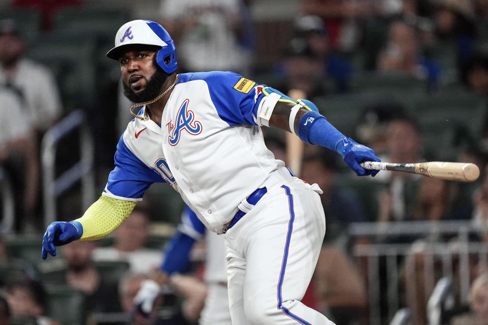 Atlanta Braves designated hitter Marcell Ozuna hits a single in the seventh inning of a baseball game against the Milwaukee Brewers, Friday, July 28, 2023, in Atlanta. (AP Photo/John Bazemore)