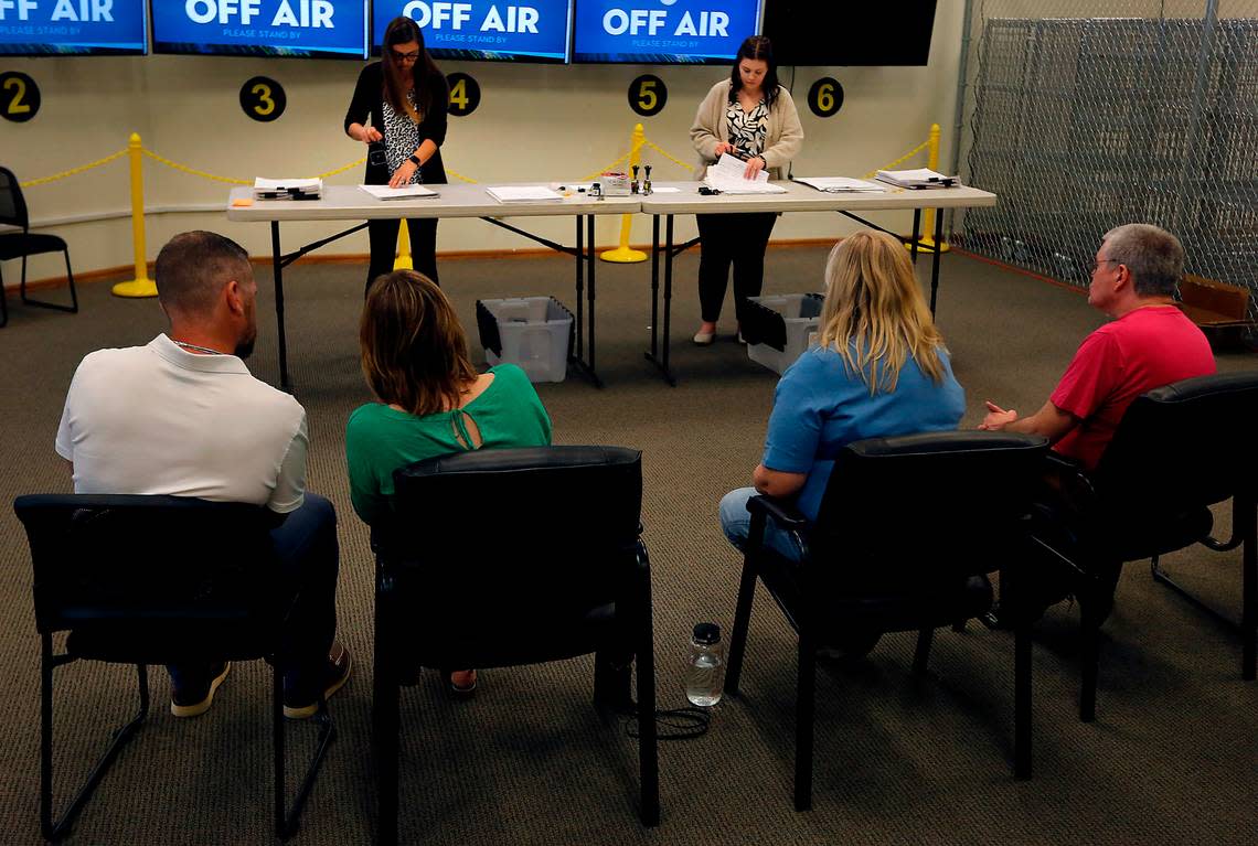 Richland residents Bradley Rew, Elizabeth Lugo, Carrie Hallquist and Roy Hallquist, from left, watch as Benton elections employees Amanda Hatfield, left, and Grace Davidson, stamp three boxes of signed recall petition papers to the Benton County Elections Center in Richland. Bob Brawdy/bbrawdy@tricityherald.com