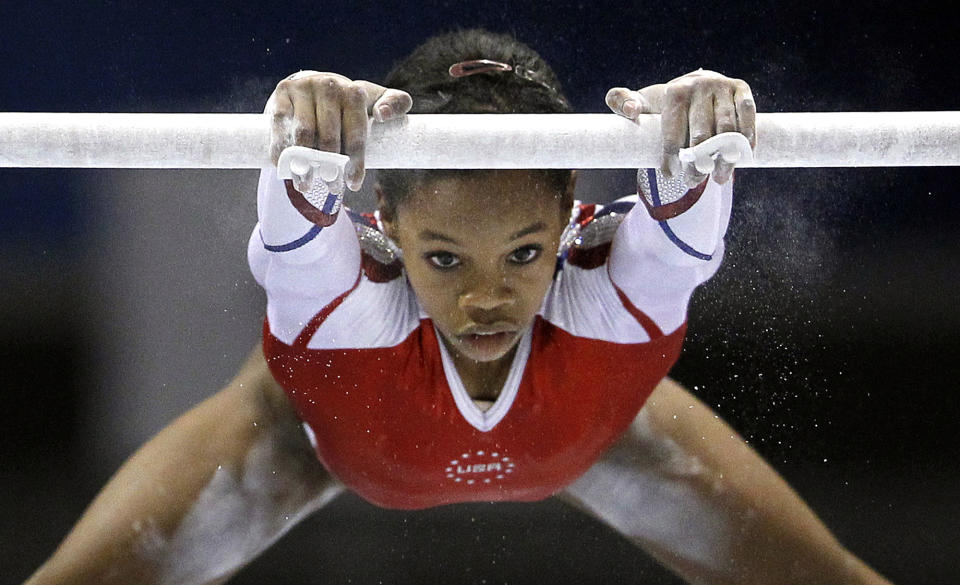 USA's Gabrielle Douglas performs on the uneven bars during the women's team final at  the Artistic Gymnastics World Championships in Tokyo, Japan, Tuesday, Oct. 11, 2011. (AP Photo/Bullit Marquez)