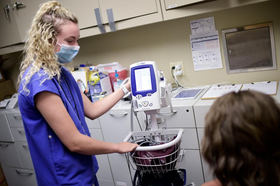 Nurse Amira Perrigan checks blood pressure at the Smiddy Clinic in Wise, Virginia.