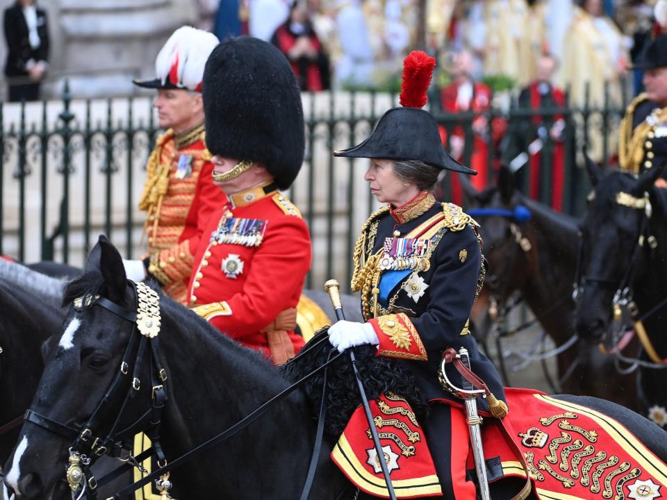 Princess Anne rides a horse during King Charles III's coronation procession.