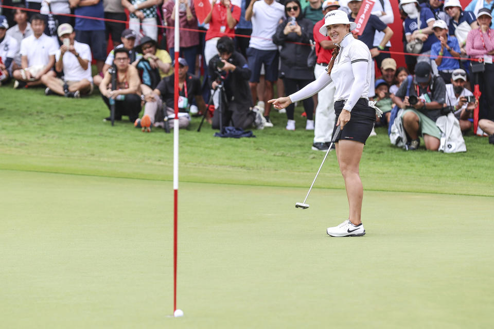 Hannah Green of Australia reacts after scoring a putt on the 18th hole during the final round of the HSBC Women's Wold Championship at the Sentosa Golf Club in Singapore Sunday, March 3, 2024. (AP Photo/Danial Hakim)