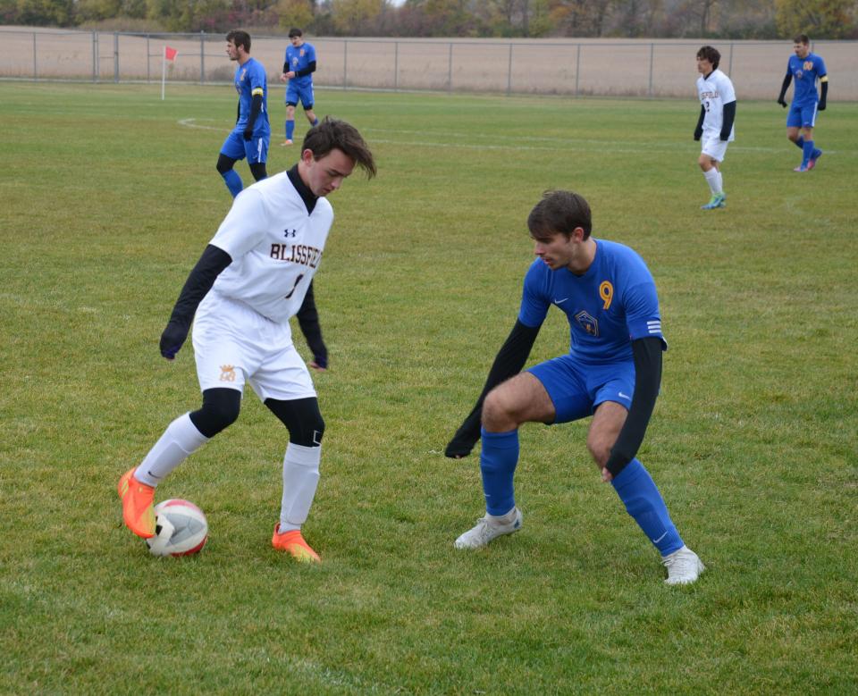 Ida's Evan Schmitz defends Clayton Retter of Blissfield in the semifinals of the Division 3 District at Milan. Schmitz has been named Monroe County Region Boys Soccer Player of the Year.