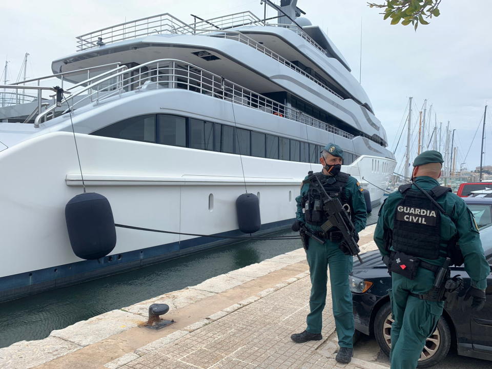 The Spanish Civil Guard stands next to the giant Tango yacht, suspected of belonging to the Russian oligarch, as it moored at the Royal Mallorca Naval Club, in Palma de Mallorca, on the Spanish island of Mallorca, Spain, April 4, 2022. Juan Poates Oliver/Handout via Reuters Provided This photo is by a third party.  Compulsory credit.