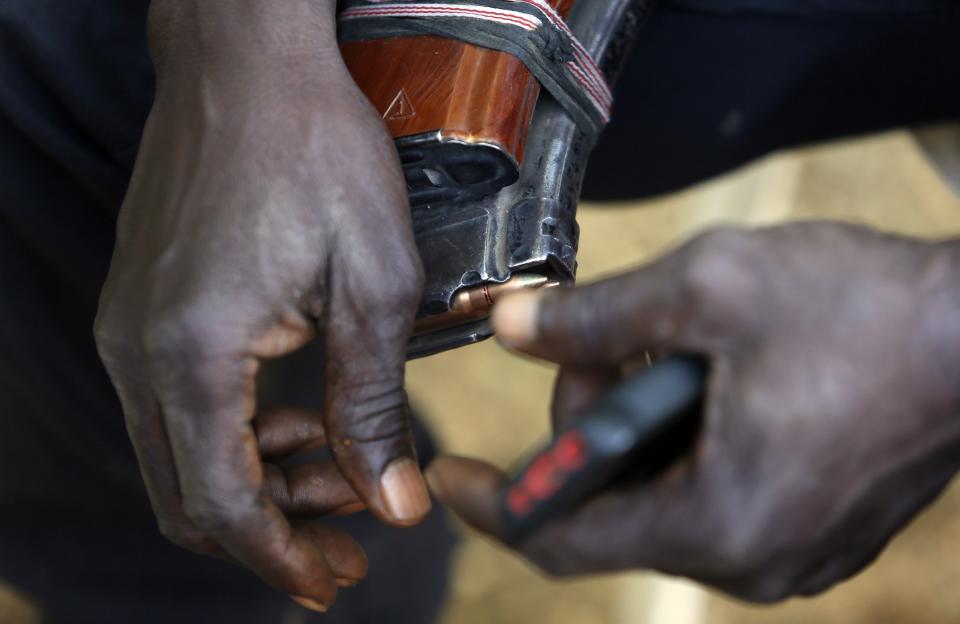 A leader of militia hunters helping the army to fight the Boko Haram insurgence in the northeast region of Nigeria, holds a magazine of bullets in his hands during an interview in Yola, Adamawa State January 14, 2015. Boko Haram says it is building an Islamic state that will revive the glory days of northern Nigeria's medieval Muslim empires, but for those in its territory life is a litany of killings, kidnappings, hunger and economic collapse. Slowly, with the help of traditional hunters armed with home made guns and a reputation for magic powers, government forces have pushed Boko Haram out of some of its southern possessions. Picture taken January 14, 2015. To match Insight NIGERIA-BOKOHARAM/ REUTERS/Afolabi Sotunde (NIGERIA - Tags: CIVIL UNREST MILITARY)