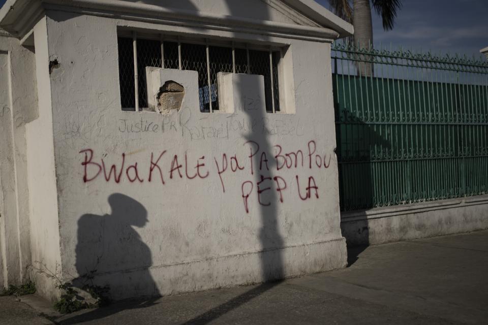 Graffiti that reads in Haitian Creole: "Bwa Kale is not good for the people" covers what it was once a security booth outside the presidential palace, before it was destroyed during the 2010 earthquake, in downtown Port-au-Prince, Haiti, Thursday, June 1, 2023. A vigilante movement dubbed “bwa kale” means “peeled wood” and insinuates male dominance and power in street slang. (AP Photo/Ariana Cubillos)