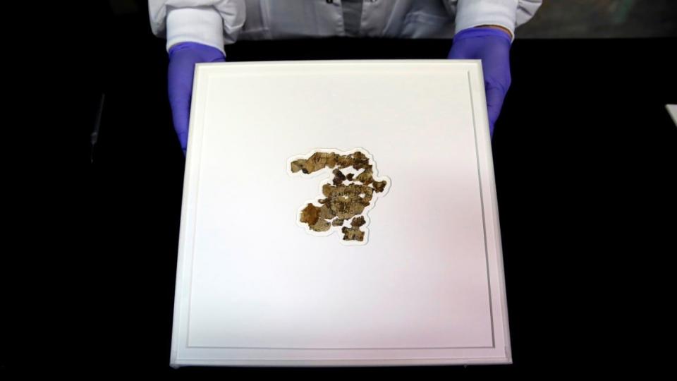 <div class="inline-image__caption"><p>A staff member shows fragments of the new discovered Dead Sea Scroll in a lab in the Israel Museum in Jerusalem on March 16, 2021. Israeli archaeologists have discovered dozens of fragments of a biblical scroll written in Greek in the Cave of Horror near the Dead Sea</p></div> <div class="inline-image__credit">Gil Cohen Magen/Xinhua via Getty</div>