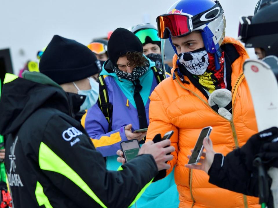 People show their EU digital Covid certificate to access ski lifts in Madonna di Campiglio, northern Italy (Flavio Lo Scalzo/Reuters)