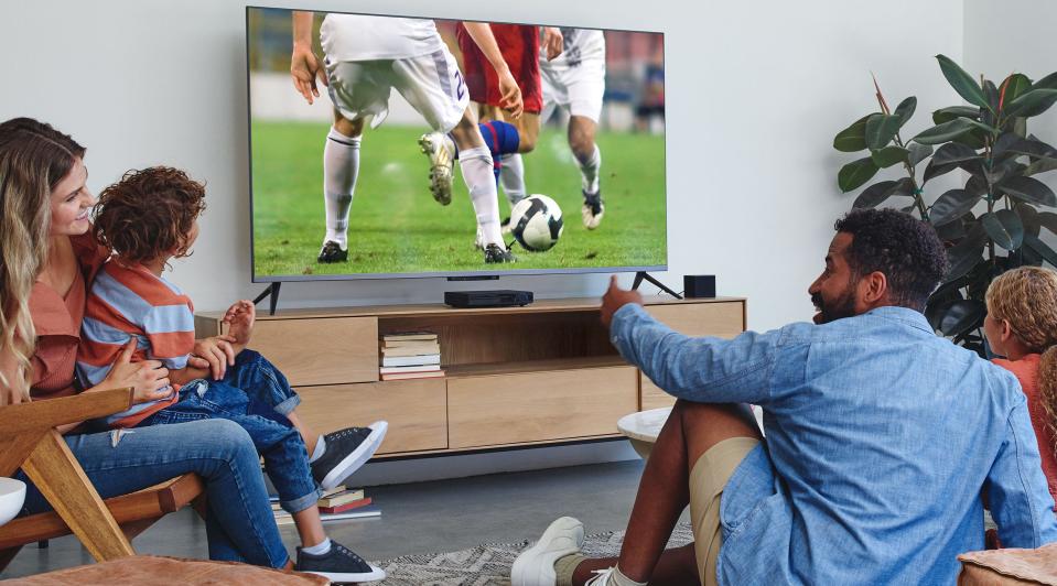 a family watching soccer on tv with the amazon fire tv 3rd gen