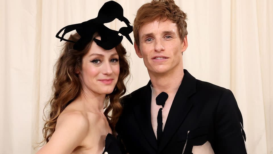 Hannah Bagshawe and Eddie Redmayne attend the event in matching Steve O Smith designs. Redmayne's suit featured large cut-outs filled with sheer flesh-toned fabric. - Mike Coppola/MG24/Getty Images for The Met Museum/Vogue