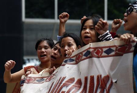 Domestic helpers rally in support of an Indonesian maid who was tortured by her employers, outside Wanchai District Court in Hong Kong September 18, 2013. REUTERS/Bobby Yip