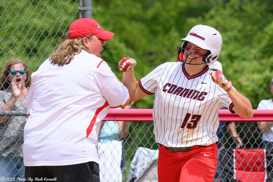 Corning head coach Stacy Johnson congratulates Grace Vondracek after Vondracek's grand slam in an 11-2 win over Niagara County Community College in an NJCAA regional final May 20, 2022 in Corning.