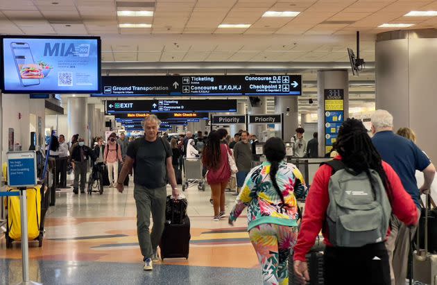 Travelers transit through Miami International Airport in Miami, Florida, on April 22, 2022. The U.S. government is appealing a court ruling that controversially lifted a federal mask mandate on public transport earlier this week, the Justice Department said on April 20. After the Centers for Disease Control and Prevention (CDC) assessed that masks remain 